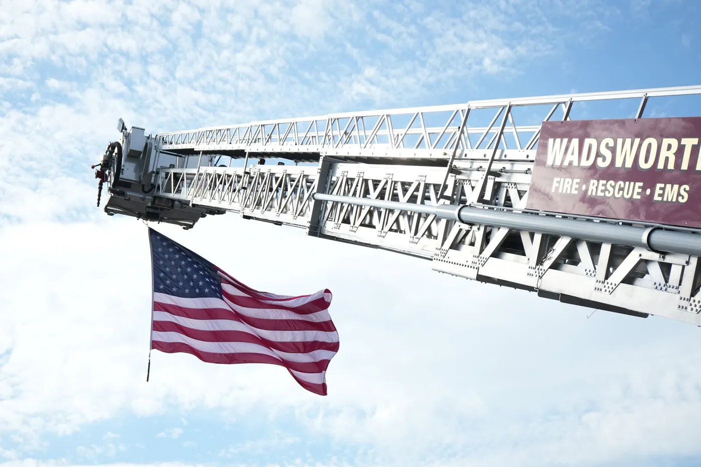 A Wadsworth Fire Rescue EMS ladder truck flying the American flag